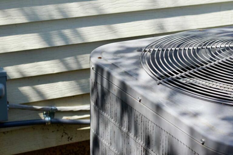 Close up view of air conditioning condenser outside a residential home