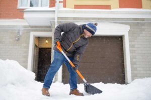 Homeowner Shoveling Snow
