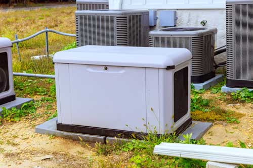 Natural-gas home backup generator installed near outdoor HVAC units.